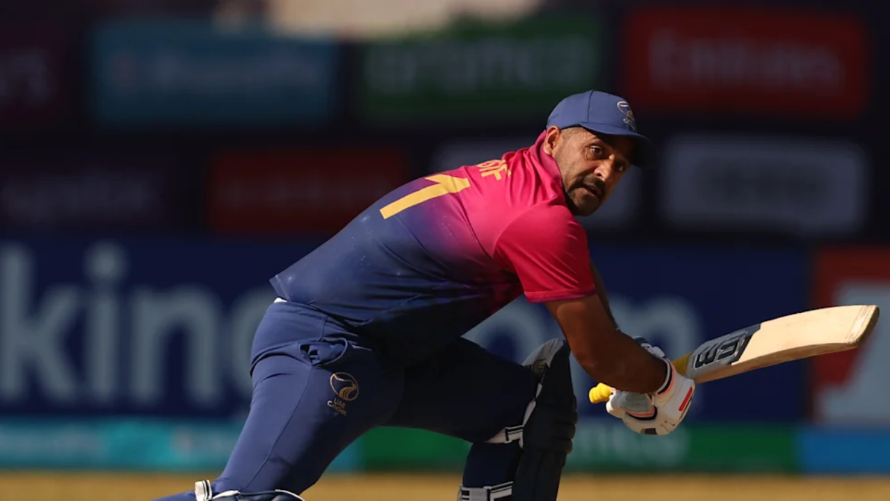 UAE cricketer Asif Khan plays a shot while batting.