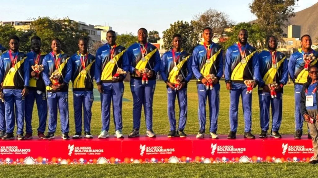 West Indies cricket team members pose with medals after competing at the 2025 Bolivarian Games, celebrating their achievement on the podium.