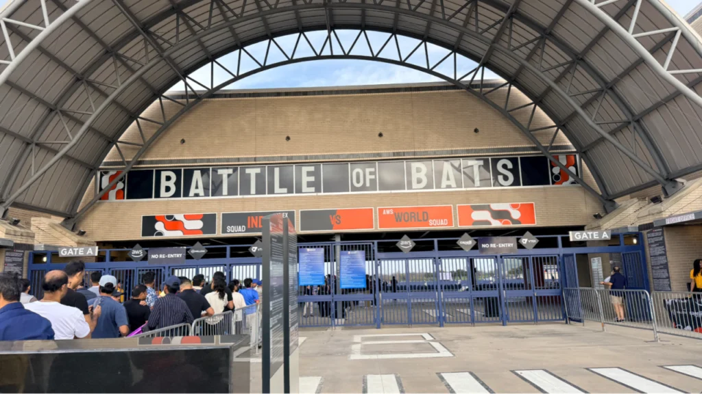 Entrance to the Battle of Bats cricket event venue with attendees arriving