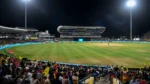 Crowd watching a Caribbean Premier League cricket match under floodlights