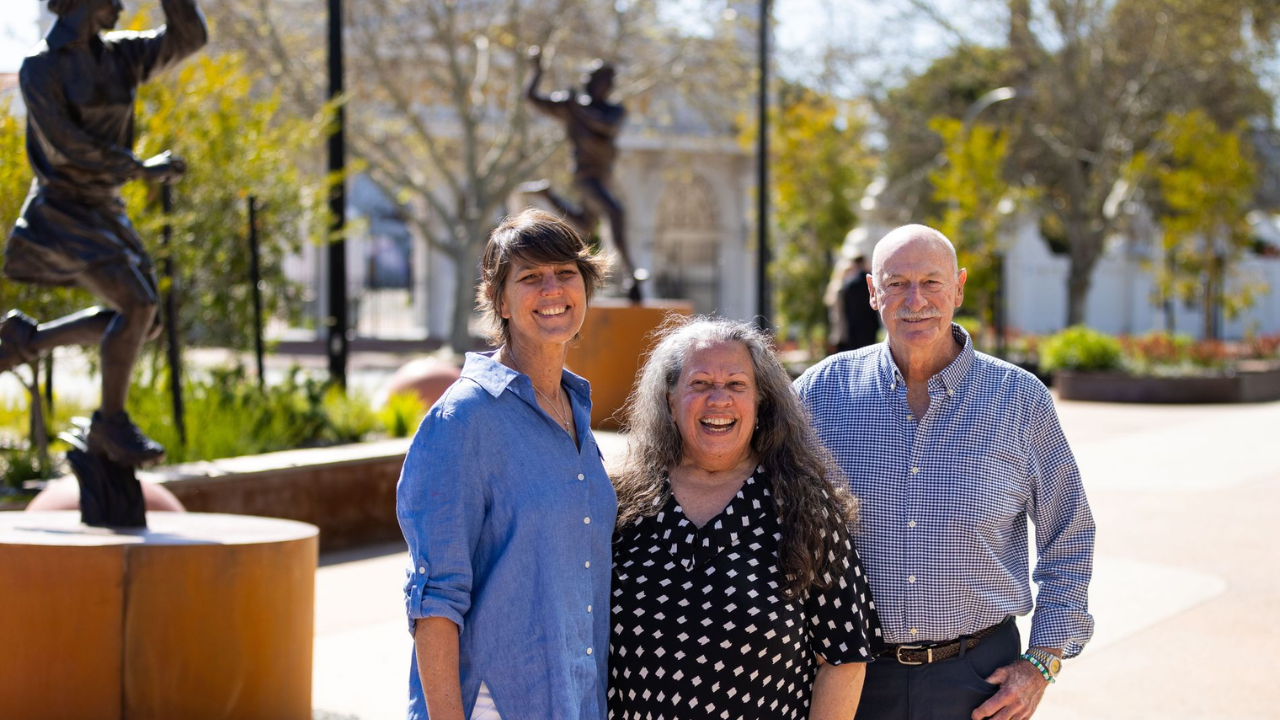 Dennis Lillee, Zoë Goss and Joseph Nogolgot pictured together outdoors.
