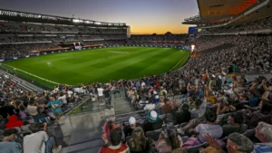 Crowd watches a cricket match under lights at Eden Park in Auckland, New Zealand