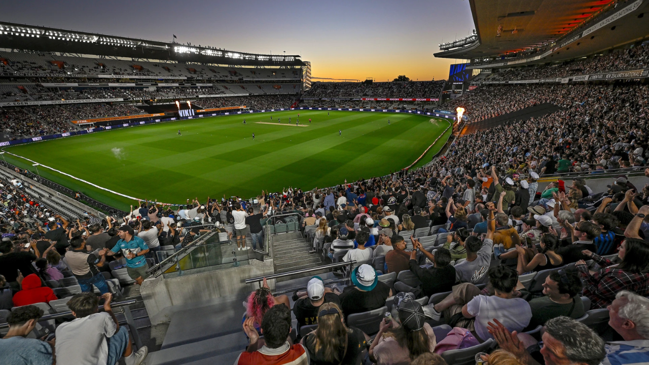 Crowd watches a cricket match under lights at Eden Park in Auckland, New Zealand