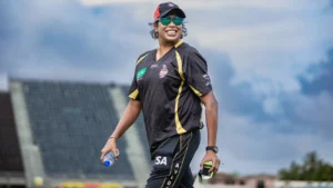 Jhulan Goswami pictured at a cricket ground wearing team training kit.