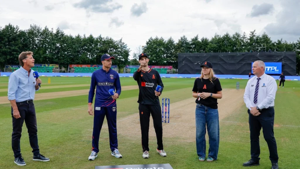 Noor van Rietschote joins players and officials for the coin toss during an ETPL cricket match.