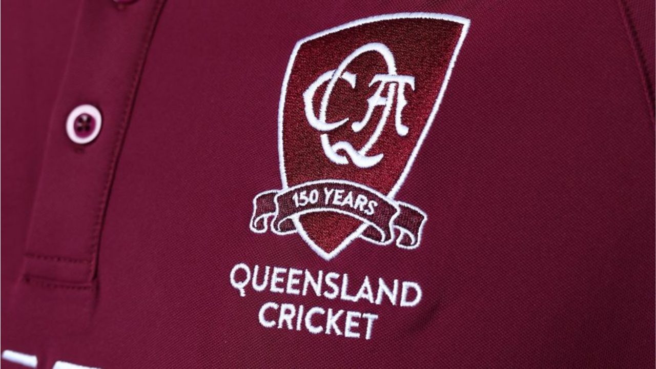 Queensland Cricket 150 Years anniversary logo embroidered on a maroon shirt