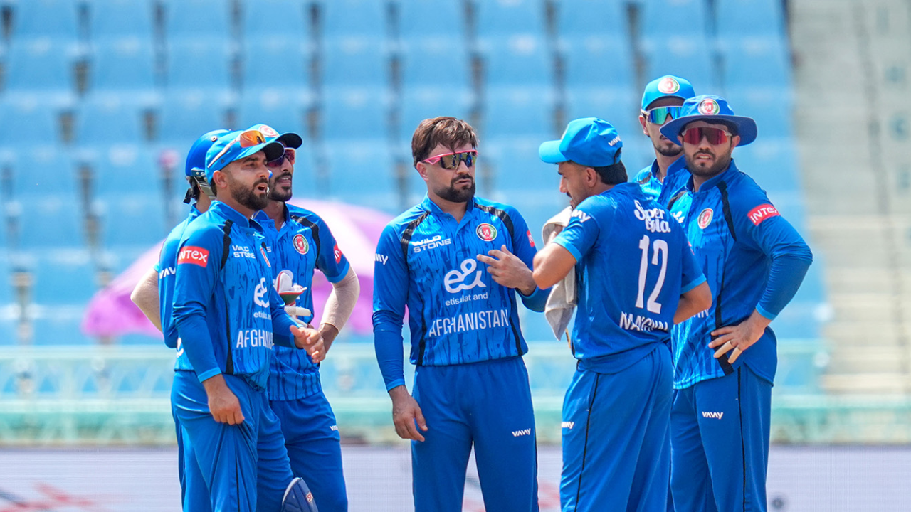Rashid Khan with Afghanistan cricket team players during a match.