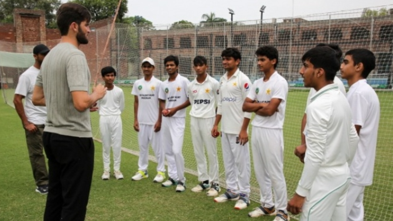 Shaheen Shah Afridi speaks with young cricketers during a training session
