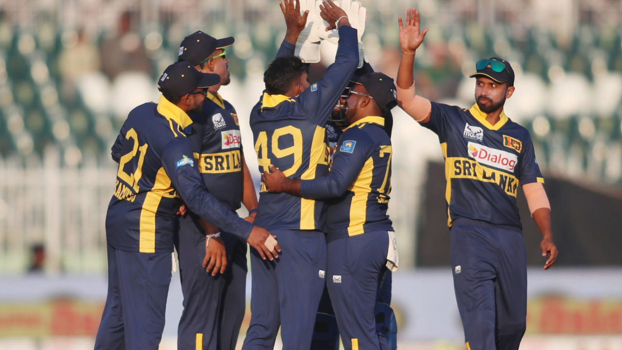 Sri Lanka national cricket team players celebrate together on the field during a match