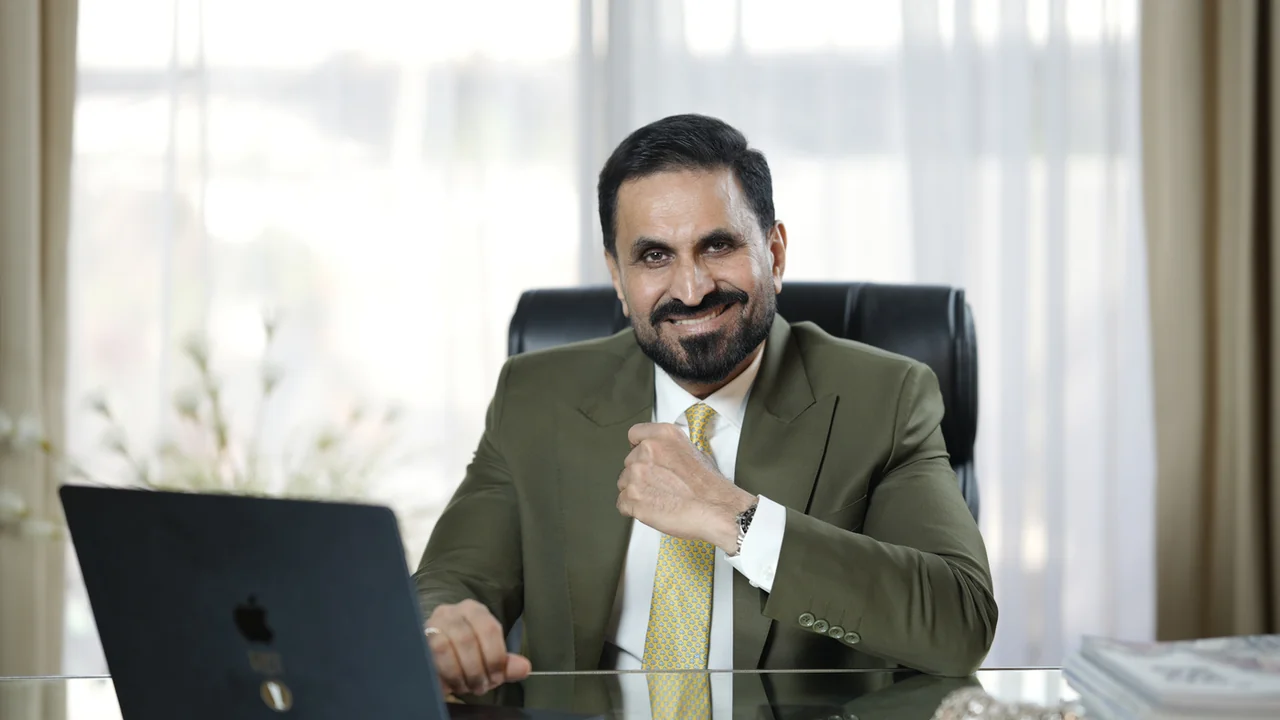 Mohammad Mansoor, Advisory Board Chairman of the Bahrain Cricket Federation (BCF), seated at his office desk.