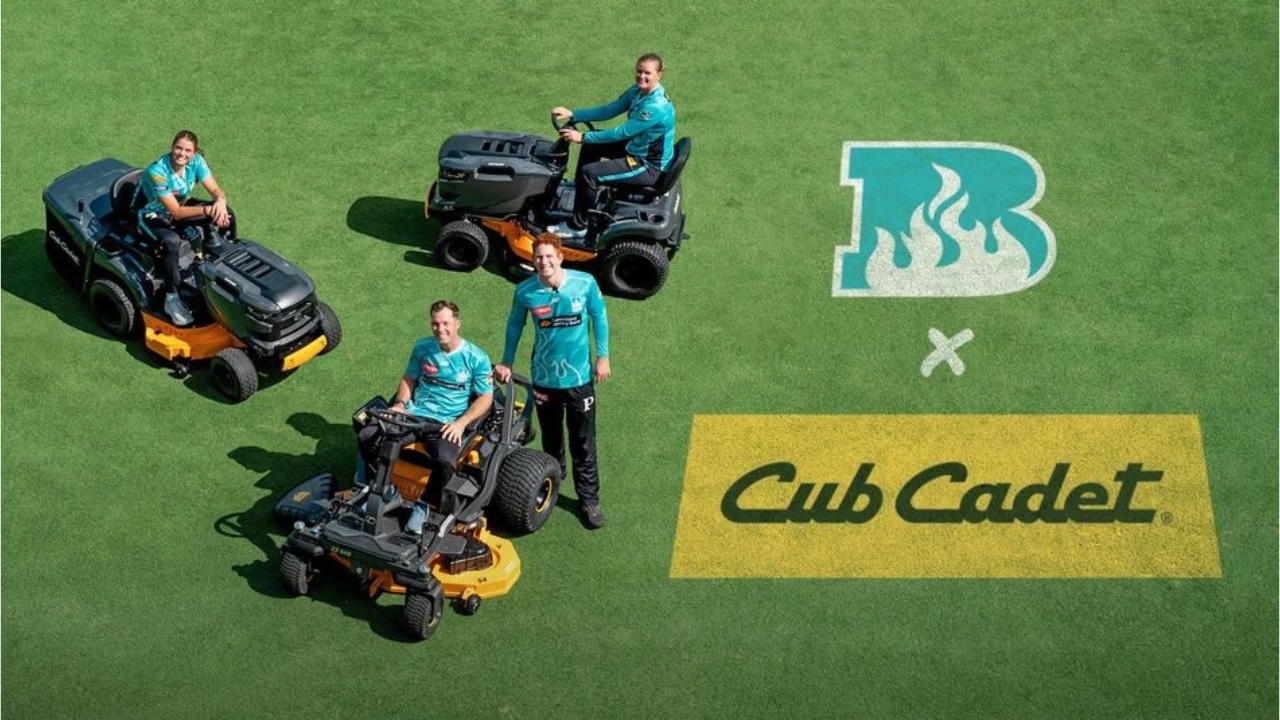 Brisbane Heat players with Cub Cadet mowers celebrating the club's partnership with Cub Cadet