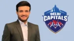 Former India cricket captain Sourav Ganguly pictured in a formal suit alongside the Delhi Capitals team logo in an IPL cricket news graphic.