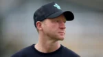 Surrey head coach Gareth Batty wearing a black Surrey cricket cap and training shirt while looking to the side.