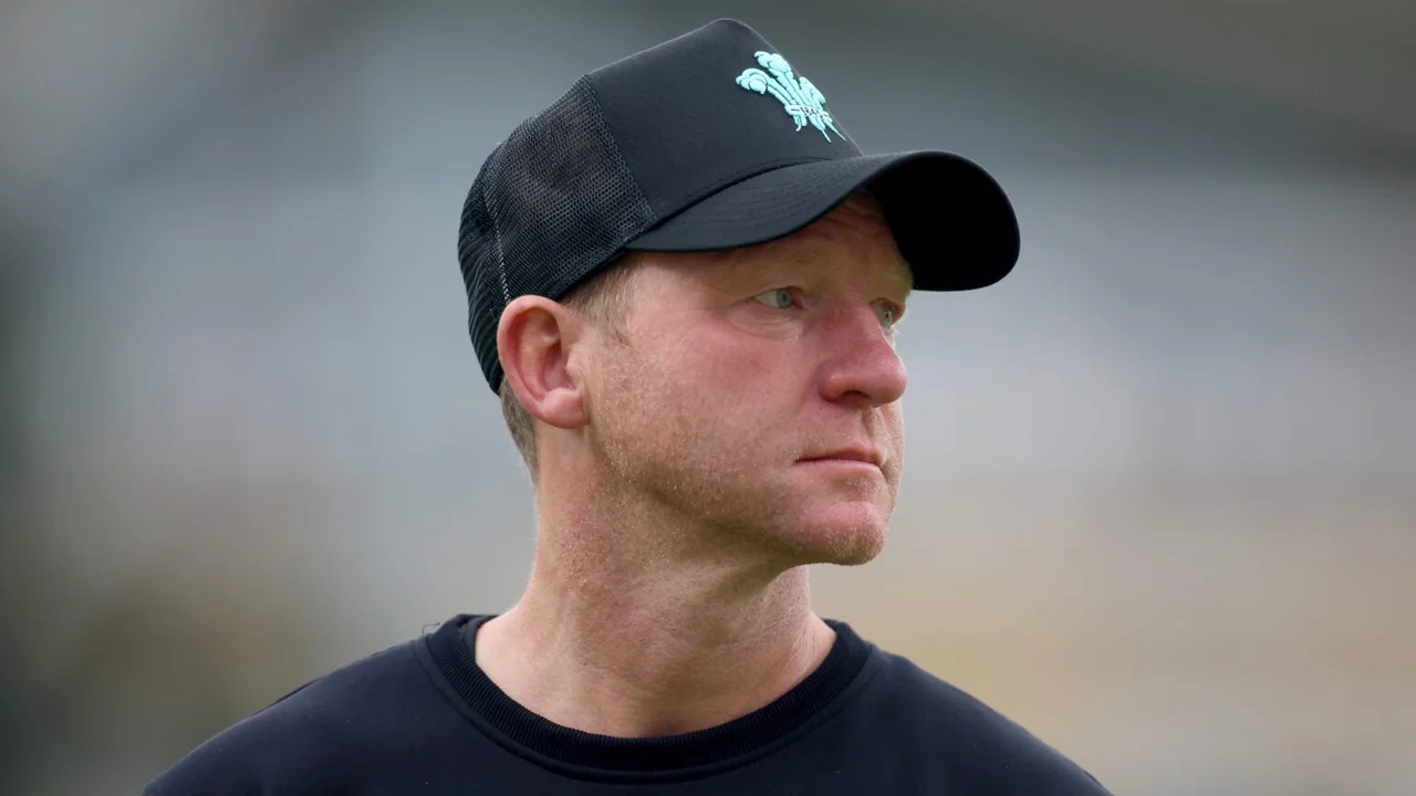 Surrey head coach Gareth Batty wearing a black Surrey cricket cap and training shirt while looking to the side.