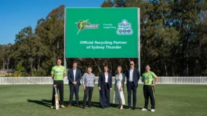 Sydney Thunder players and officials join Return and Earn representatives on a cricket field to celebrate the announcement of Return and Earn as Sydney Thunder’s official recycling partner.