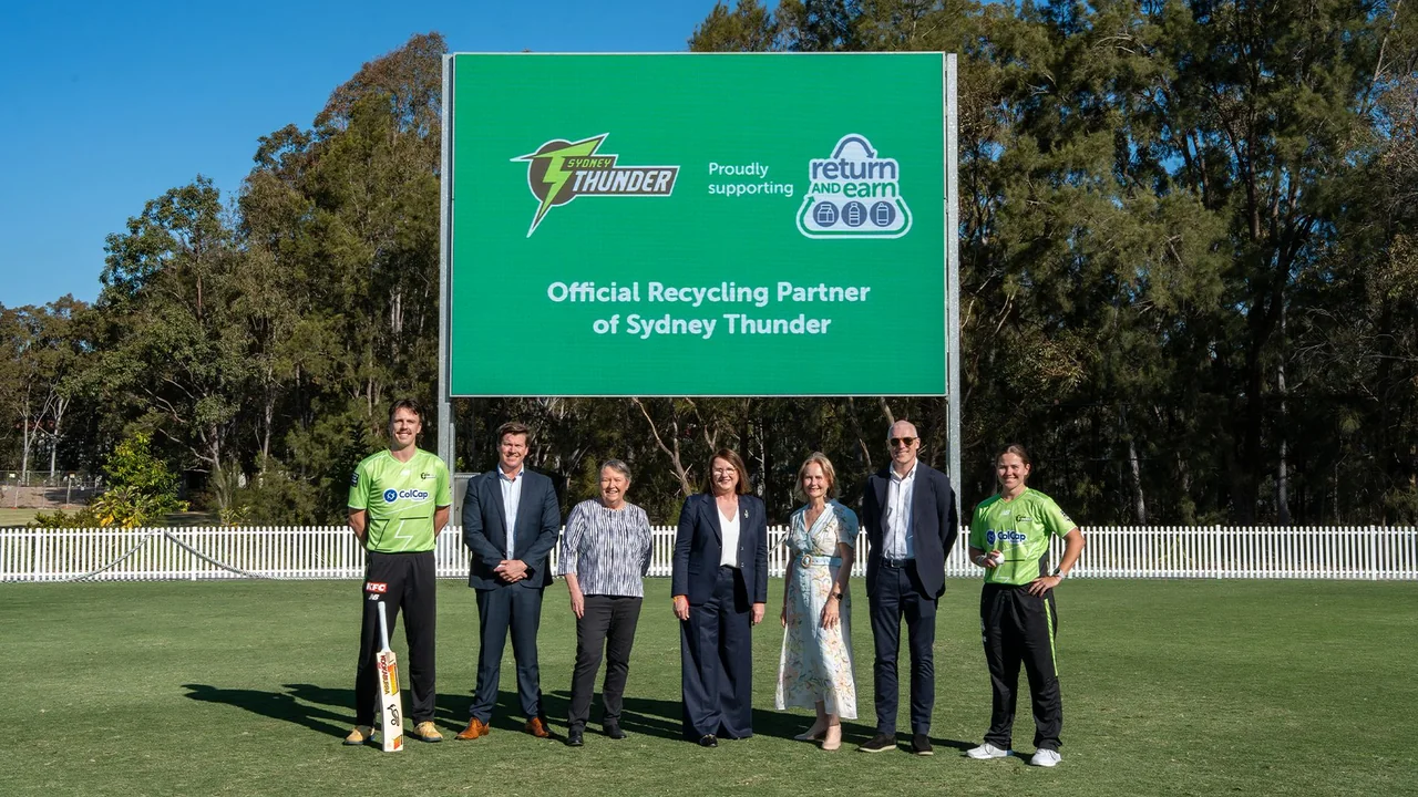 Sydney Thunder players and officials join Return and Earn representatives on a cricket field to celebrate the announcement of Return and Earn as Sydney Thunder’s official recycling partner.